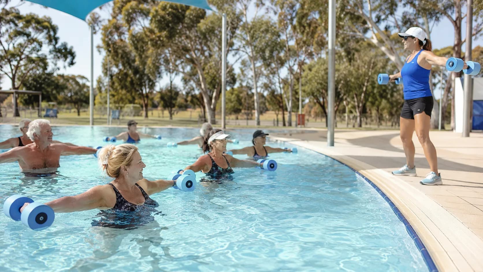 Older adults follow an outdoor aqua aerobics class in Australia