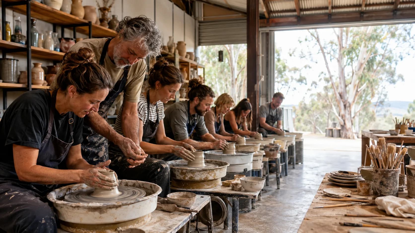 A pottery tutor guides makers during a hands-on studio class in Australia