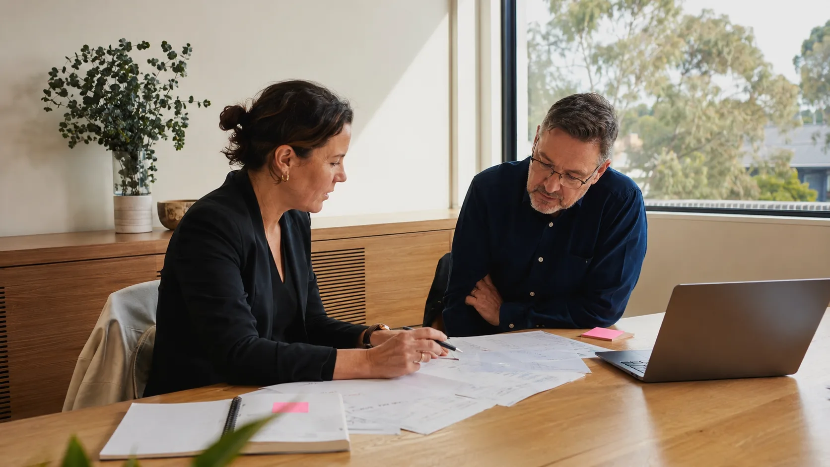 A business consultant reviews an operating plan with a client in Australia
