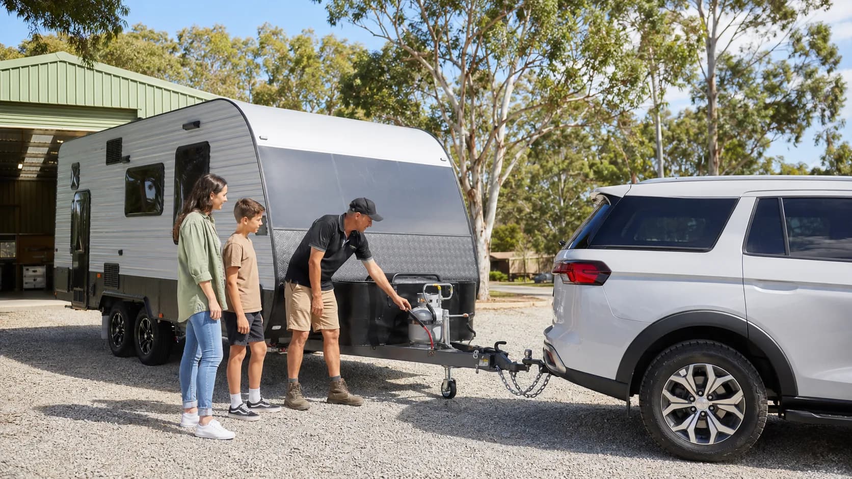 Operator demonstrating a caravan hitch at an hire yard in Australia
