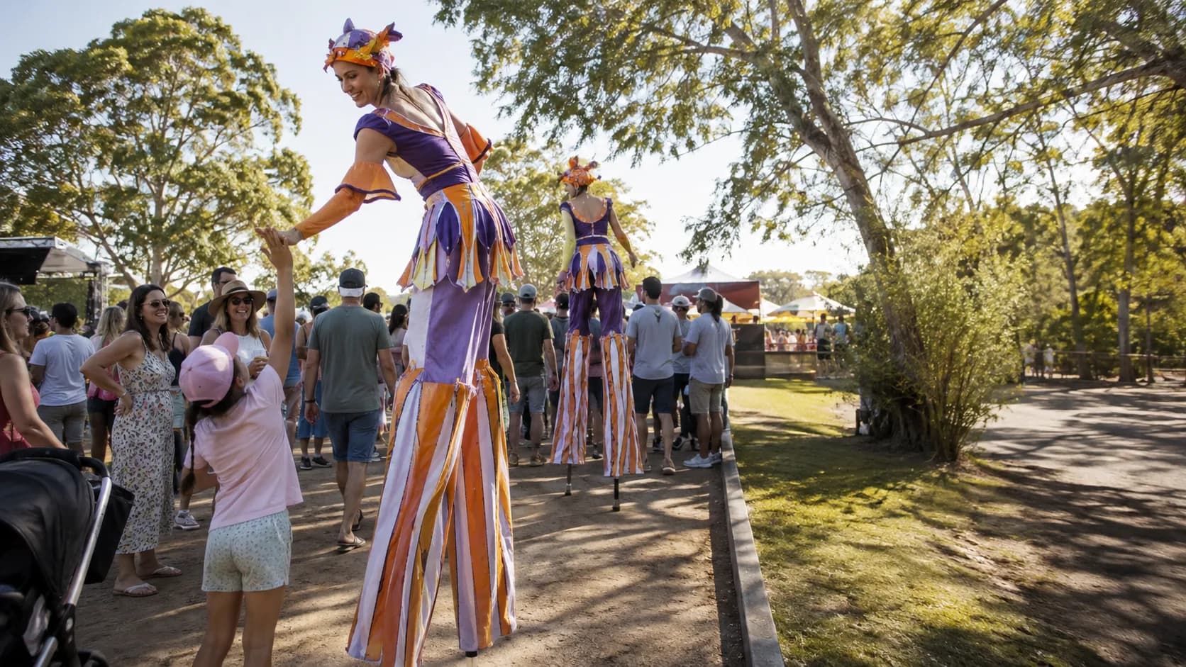 Roving circus performers entertaining a busy event crowd in Australia