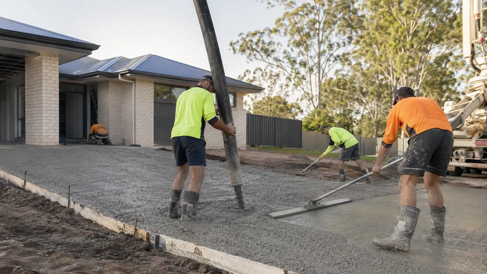 A concreter finishing a fresh slab in Australia