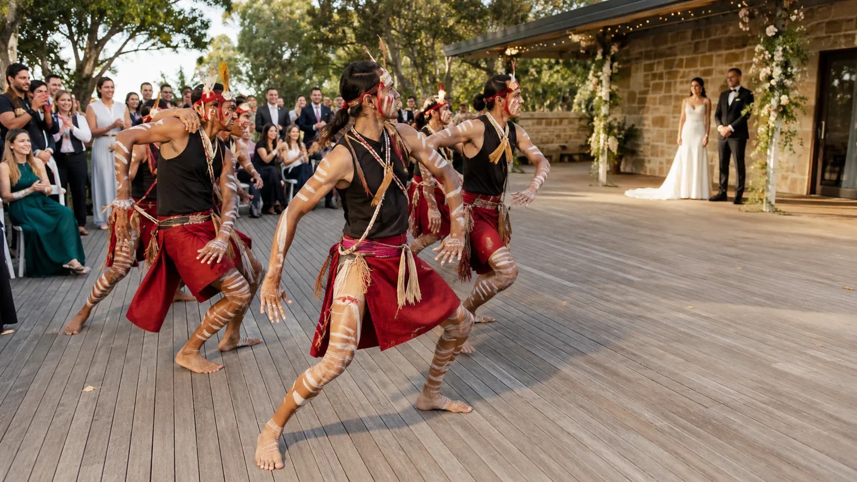 Dance troupe performing for a gathered event audience in Australia