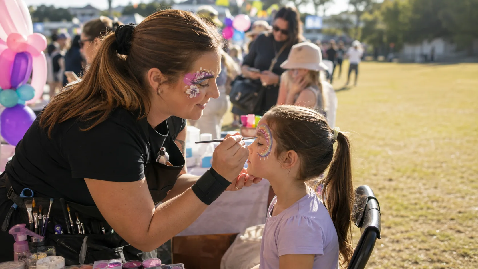 Face painter working at a busy family event in Australia
