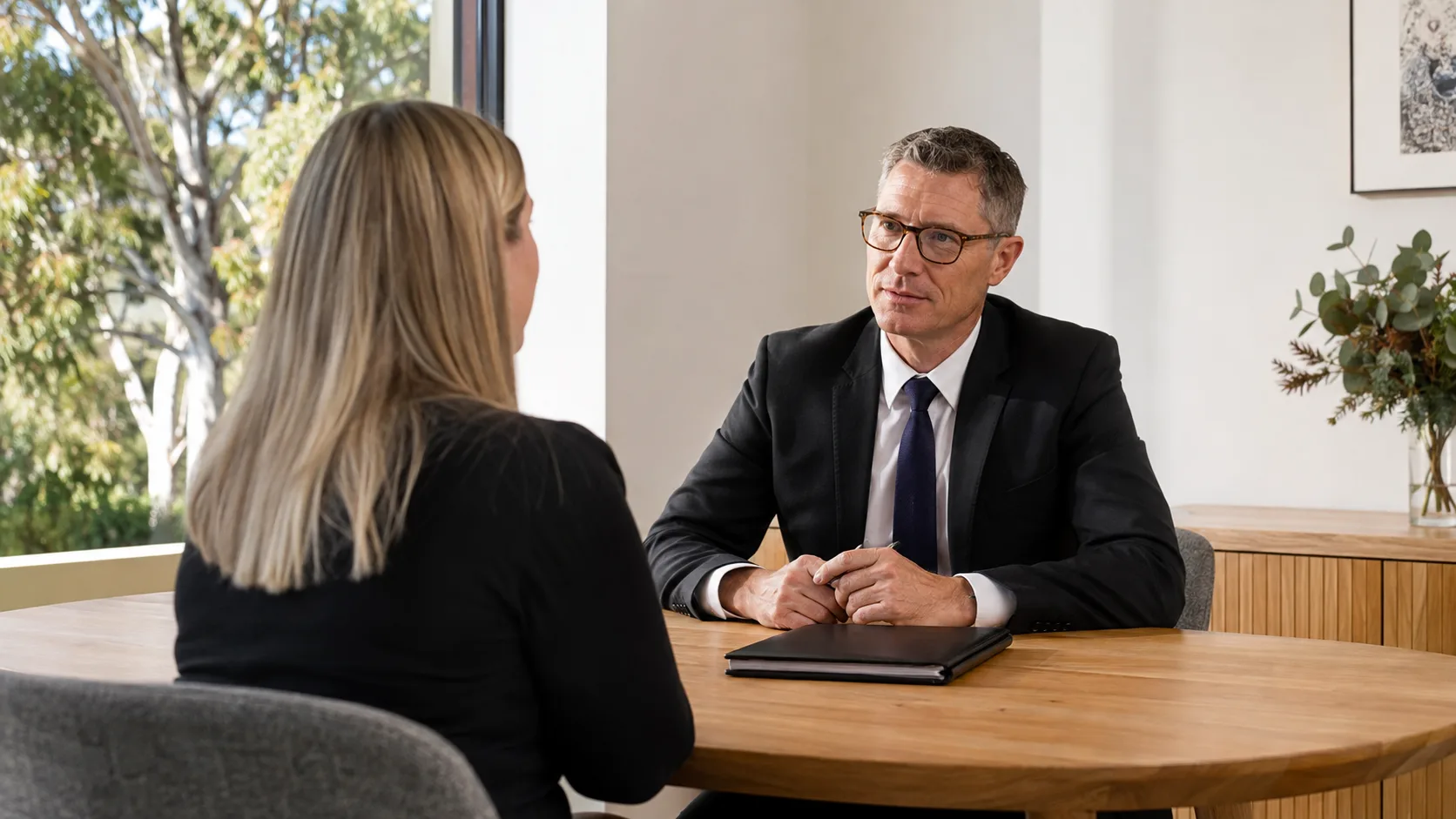 A funeral director listens during a private family appointment in Australia
