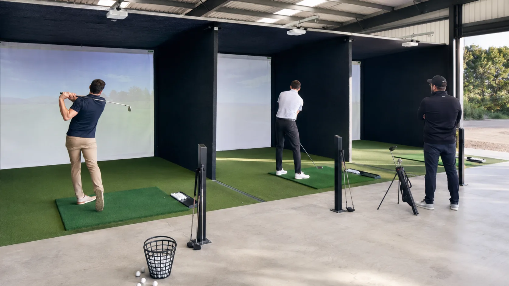 Golfers practise across bright modern indoor simulator bays in Australia