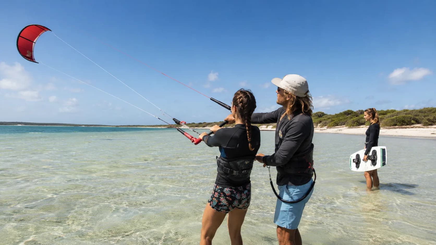 An kitesurf instructor teaches control-bar technique on a bay in Australia