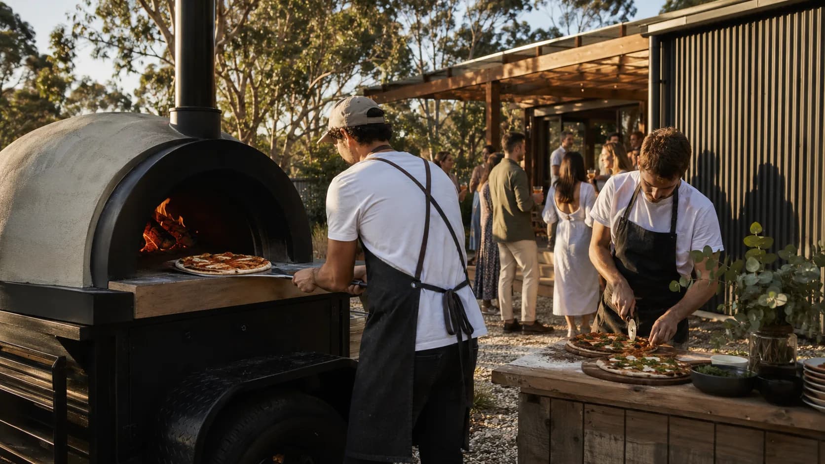 mobile pizza team serving a sunny backyard engagement party in Australia