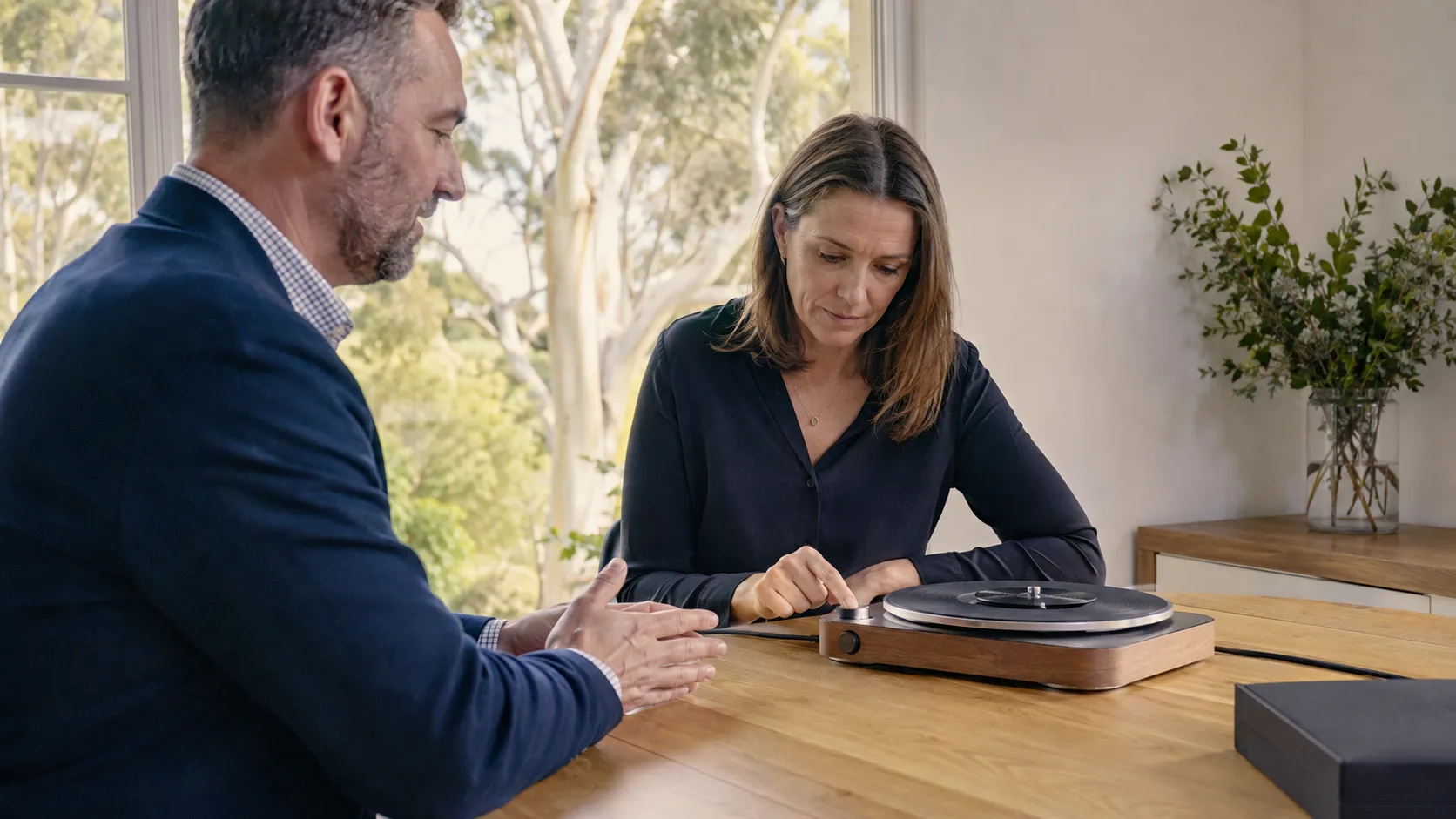 A product specialist demonstrates a device to a customer in Australia