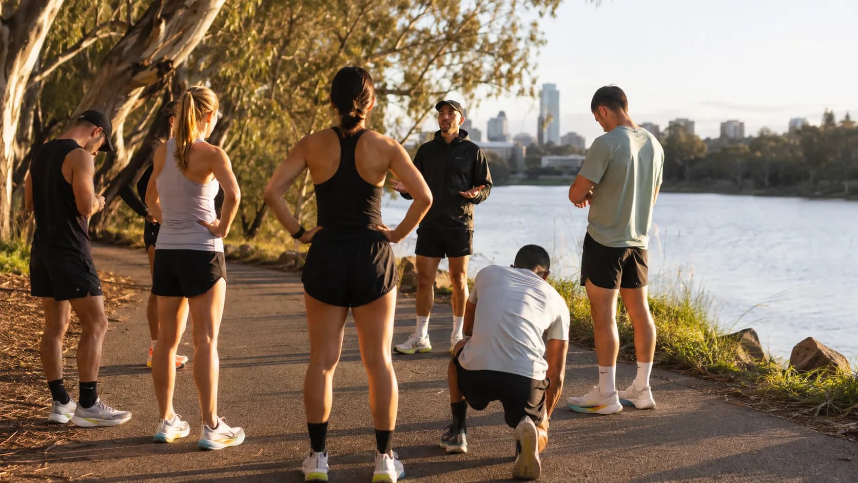 A coached run group starts a riverside session in Australia