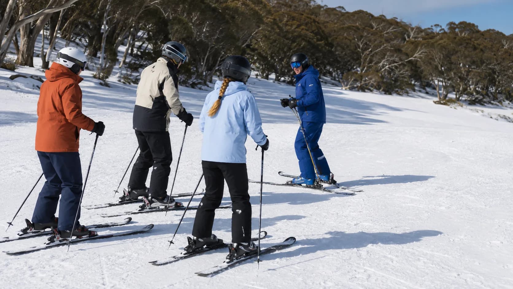 Ski instructor teaching a small group on an Australian alpine slope