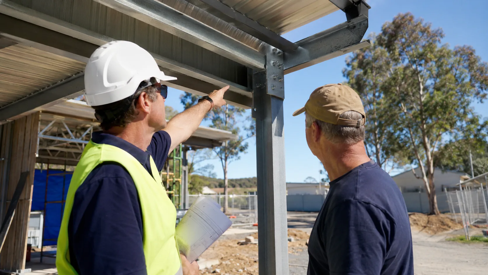 A structural engineer inspects a building connection on site in Australia