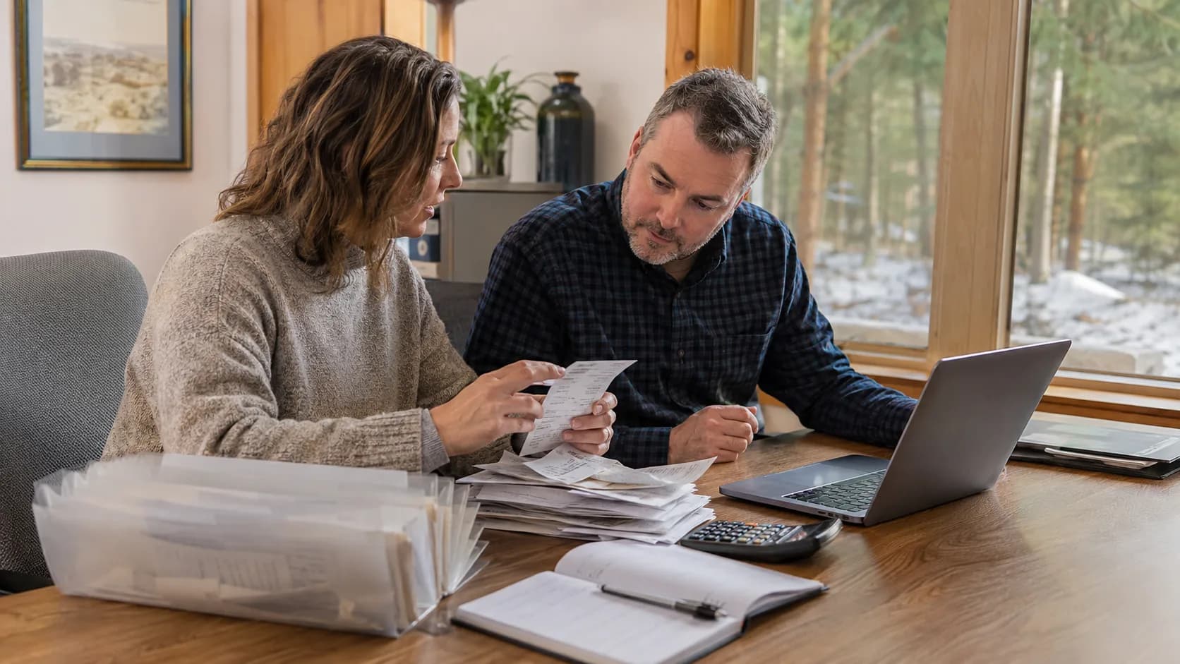 A bookkeeper works through receipts and records with a client in Canada