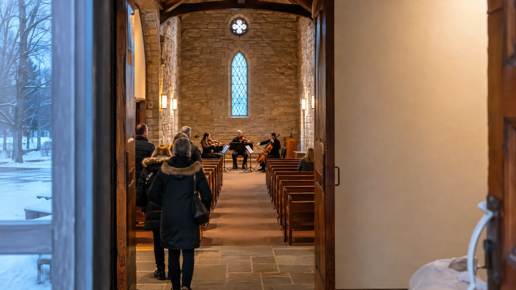 A winter wedding rehearsal fills a warm Canadian stone chapel