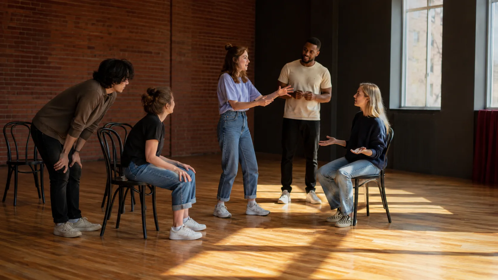 Improv group rehearsing an ensemble scene in a theatre room in Canada