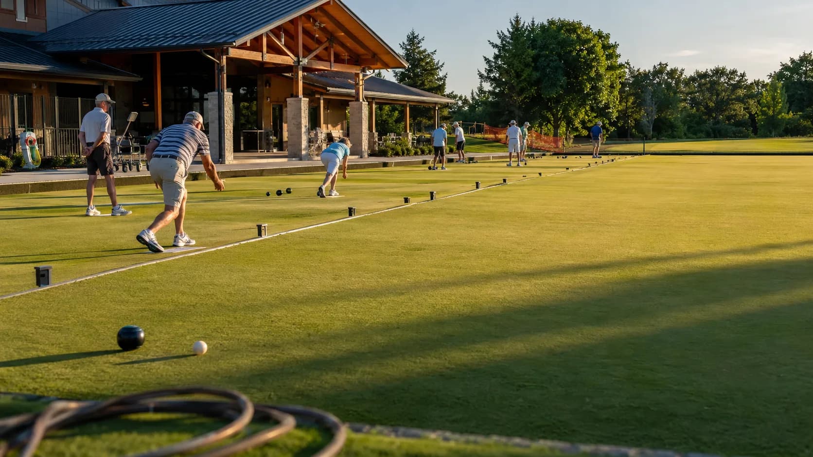 Club players bowl across a vivid summer green in Canada