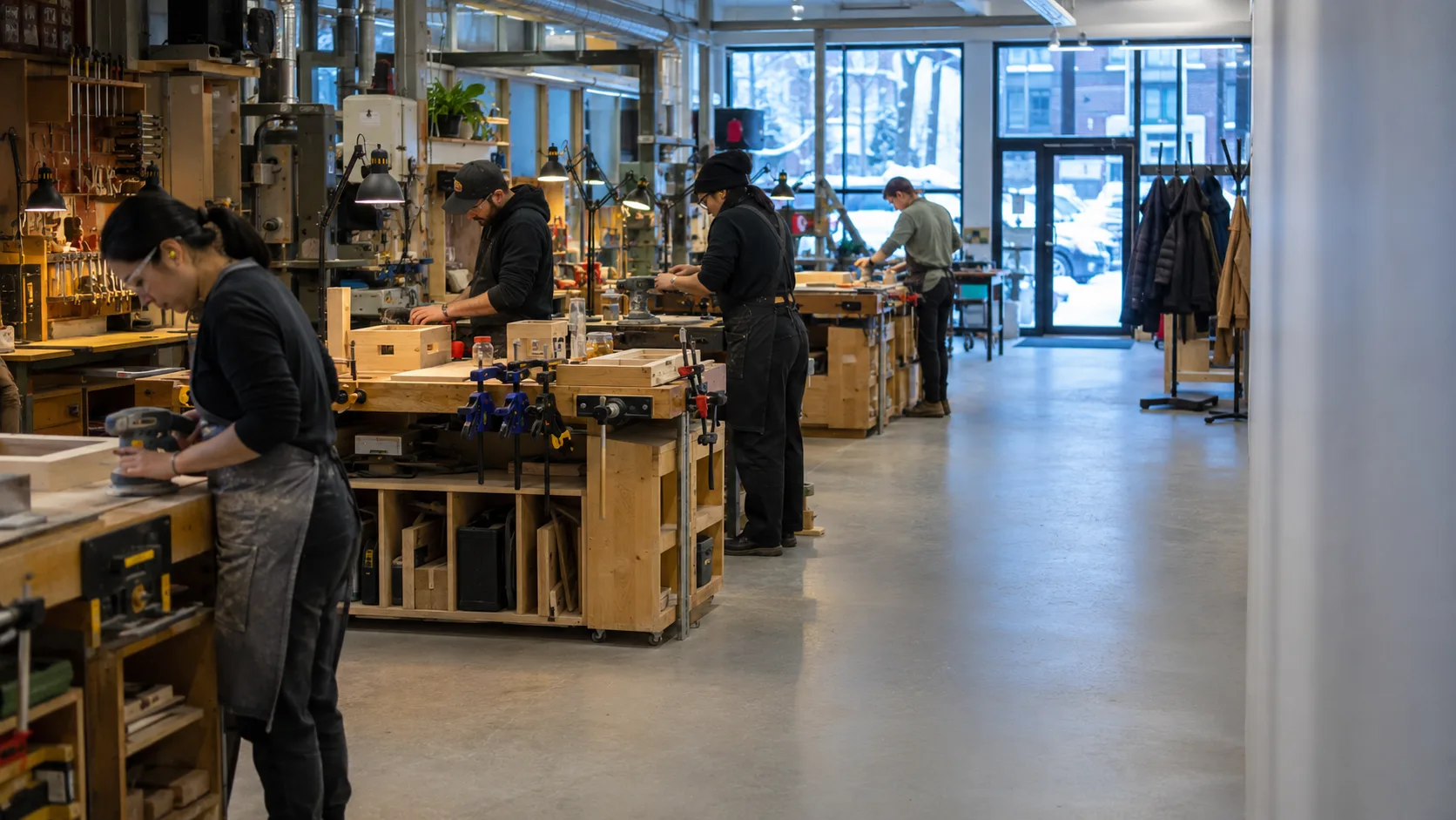 Makers work inside a warm Canadian workshop during winter evenings