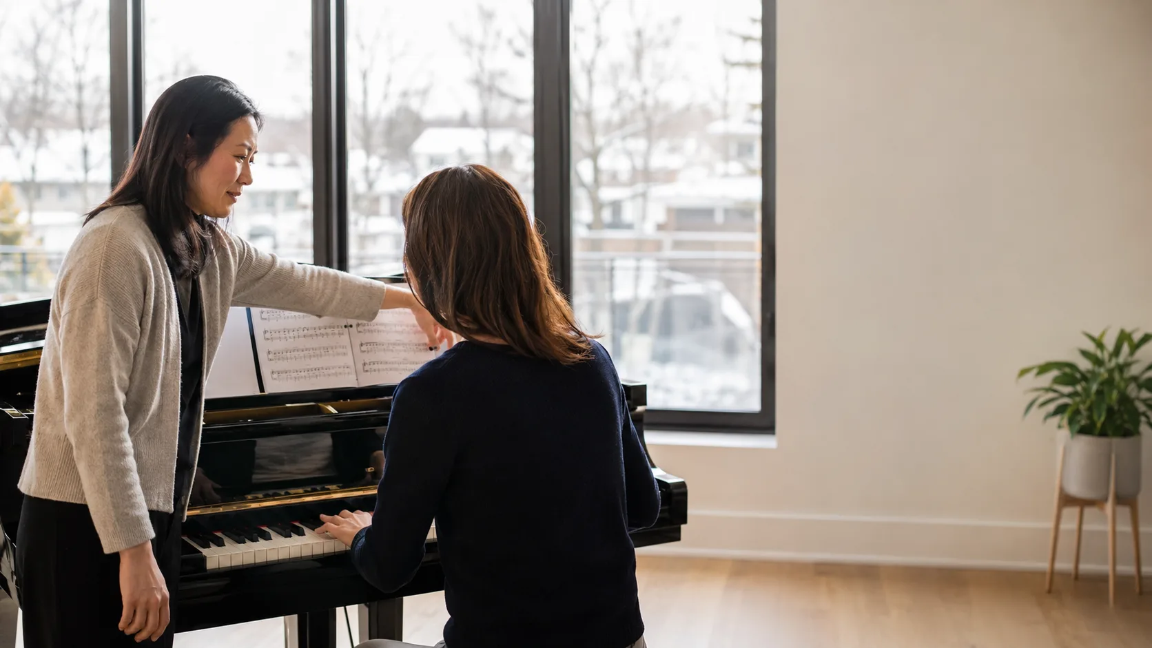 Piano teacher working with a student at a music studio in Canada