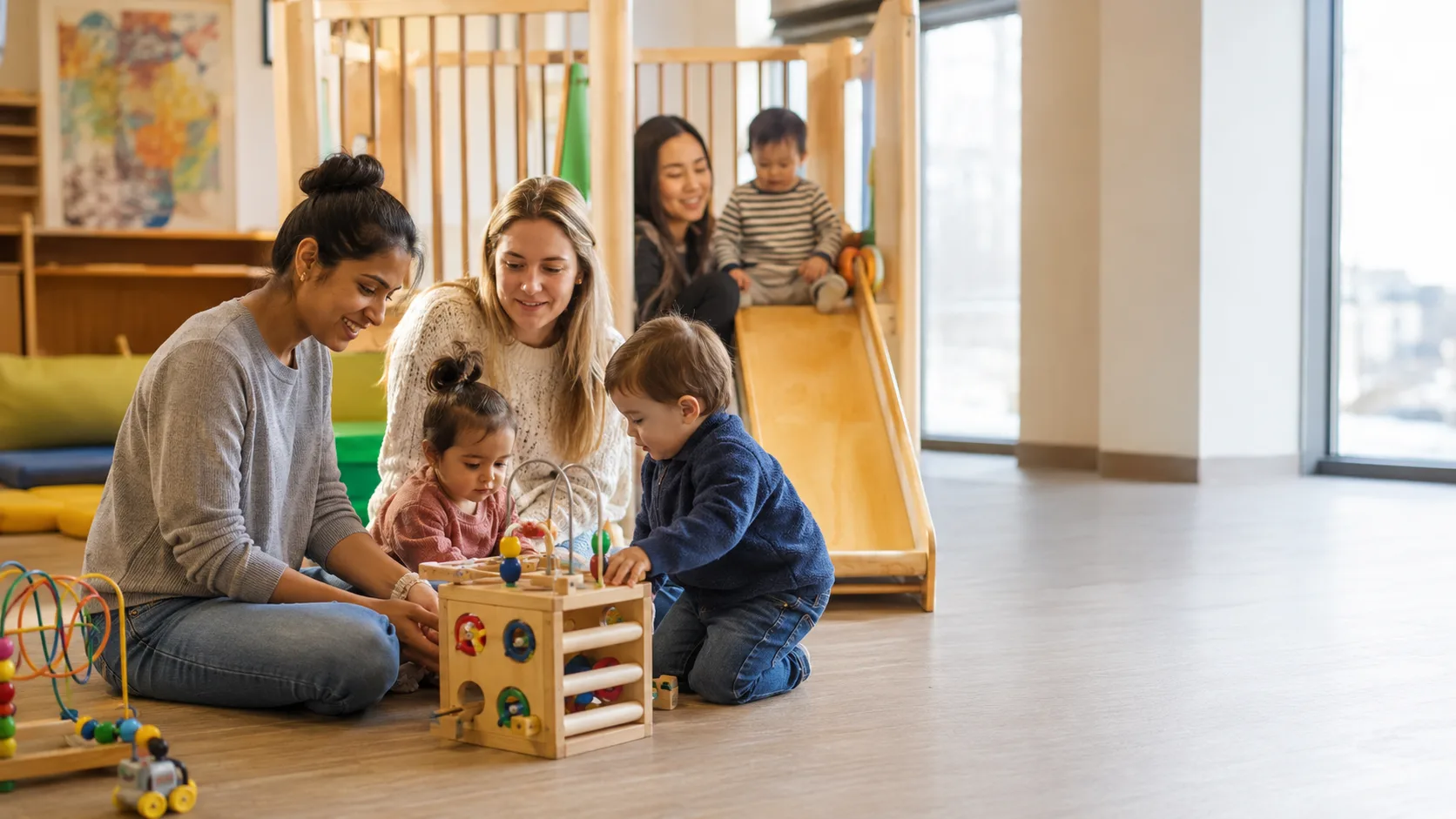 Parents and toddlers enjoying an indoor community playgroup in Canada