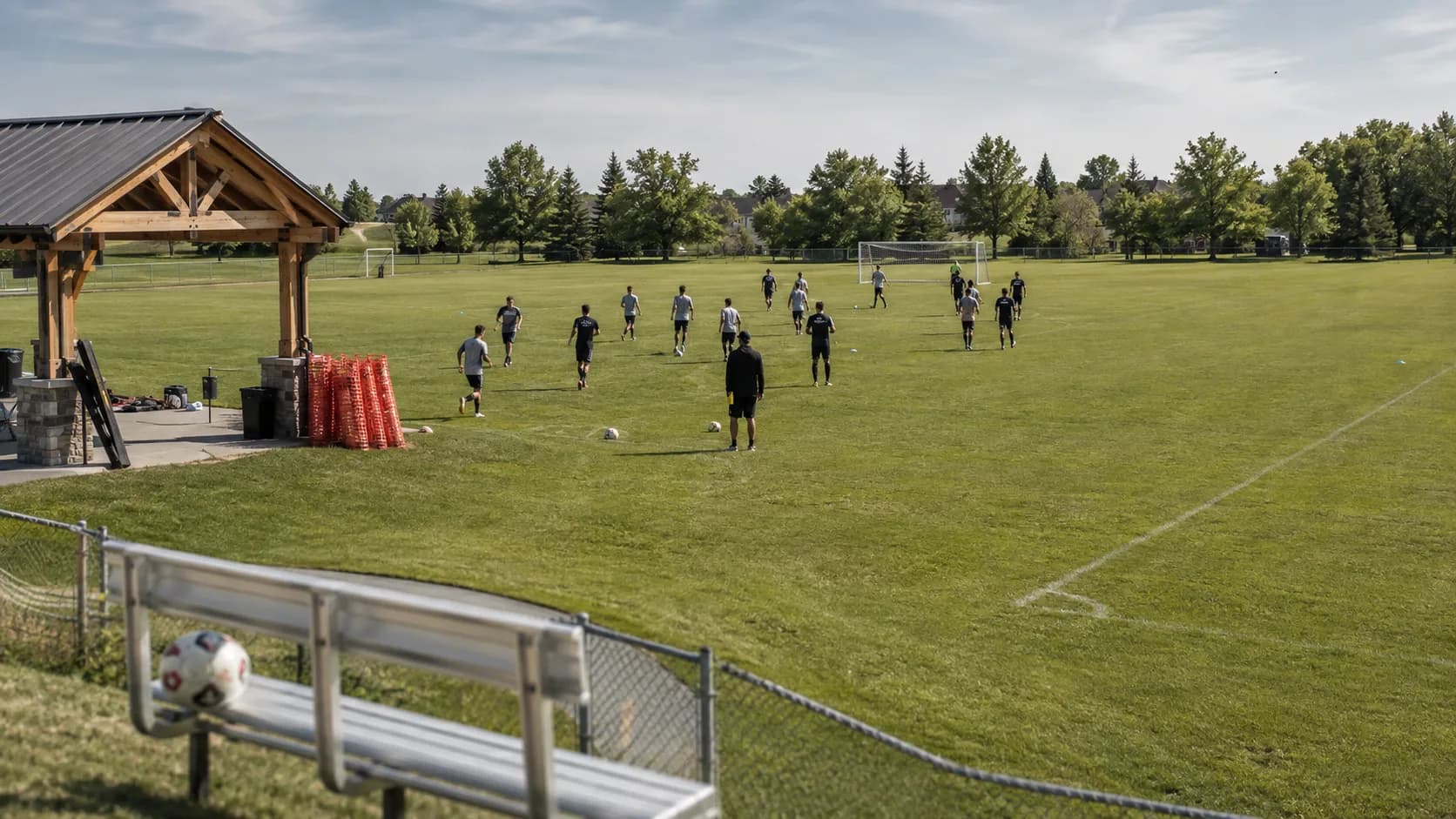 Players train across bright summer sports fields at a Canadian complex