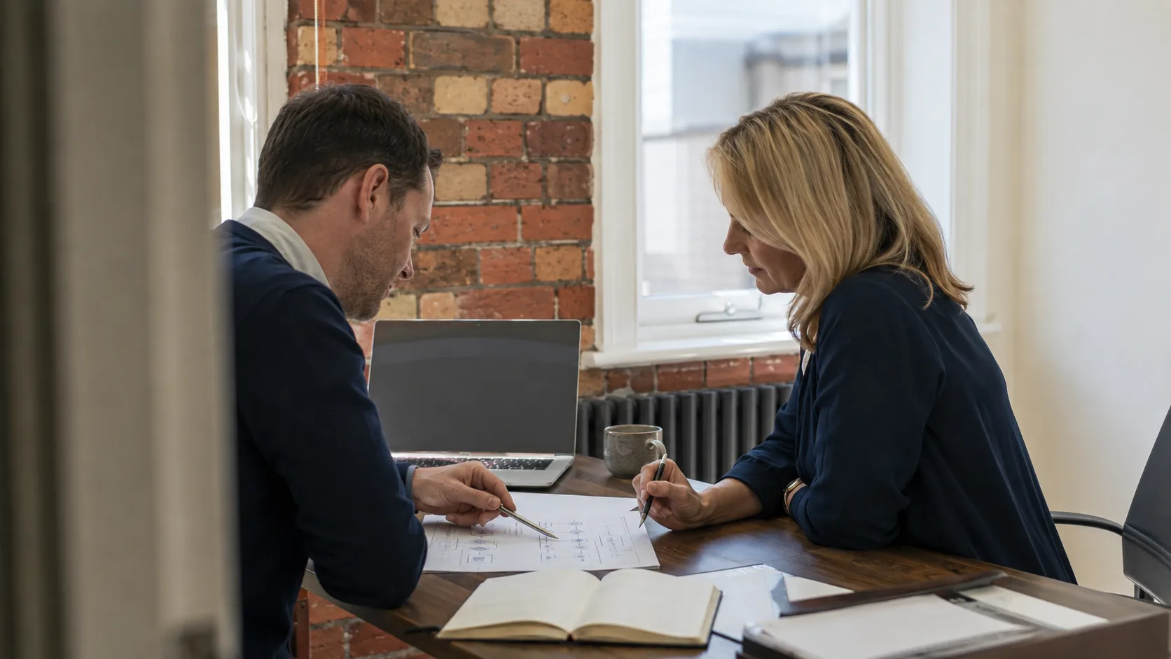 A business consultant reviews an operating plan with a client in the UK