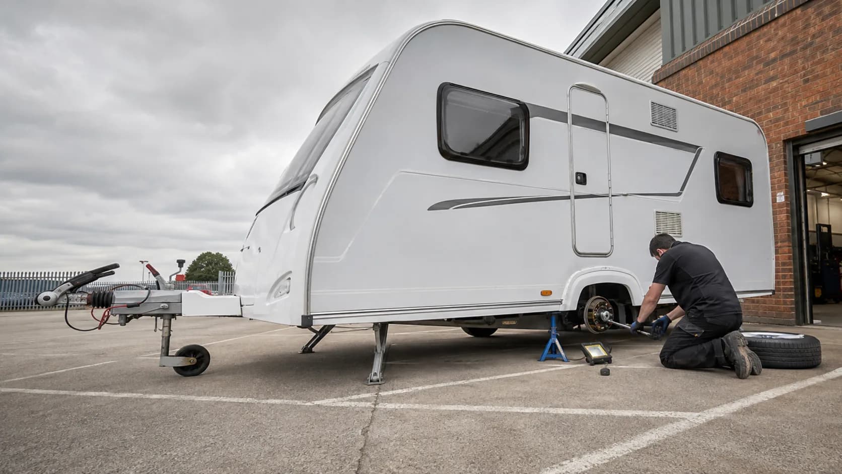 A caravan up on stands in a service workshop in the UK