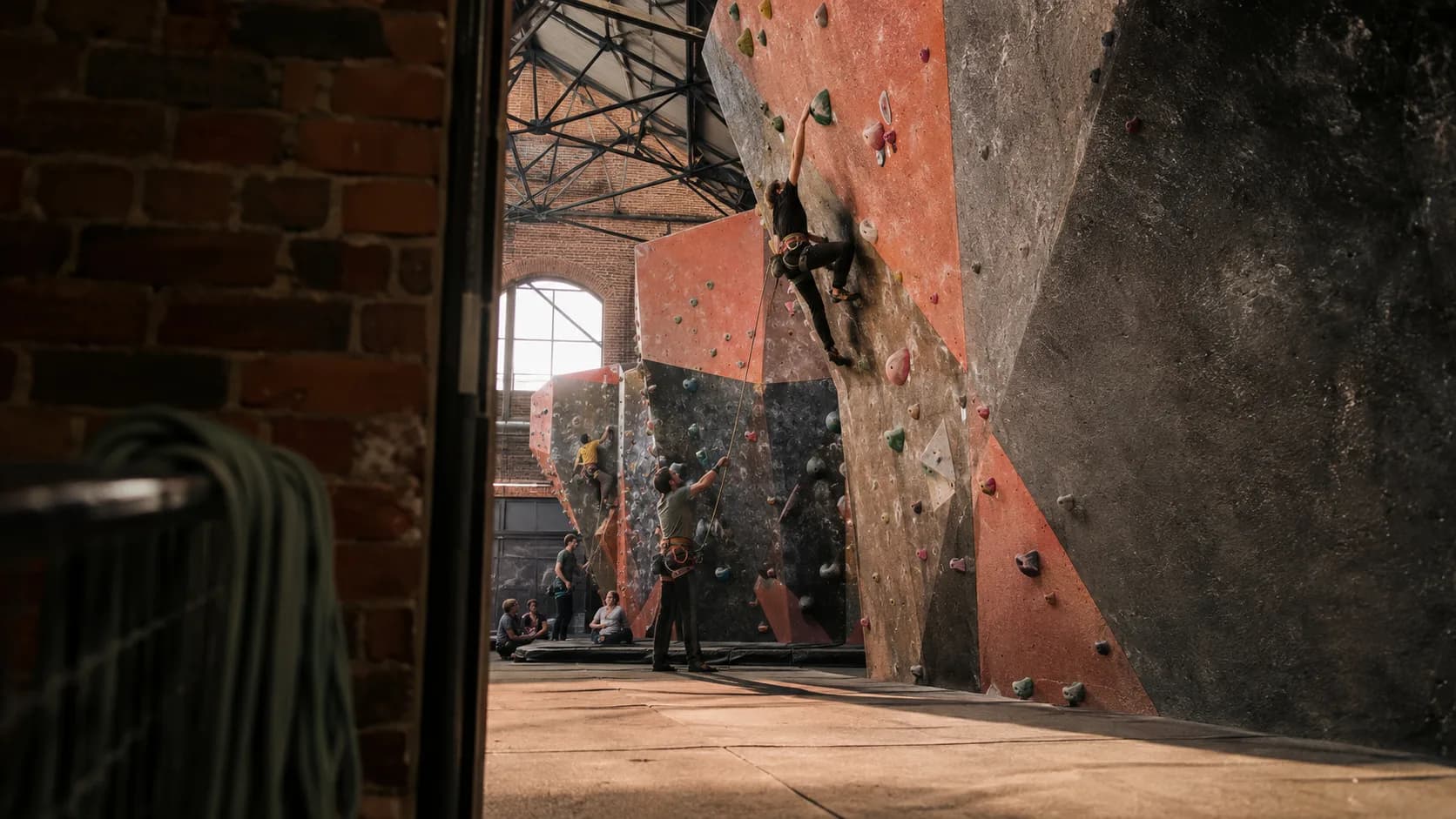 Climbers use colourful routes inside a brick climbing centre in the UK