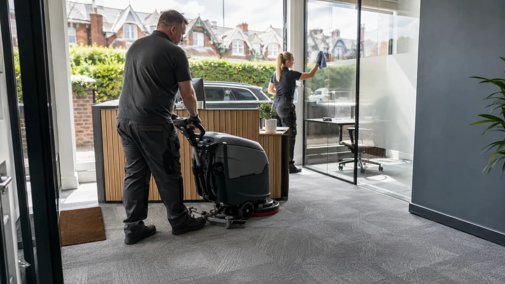 A commercial cleaner working through an office after hours in the UK