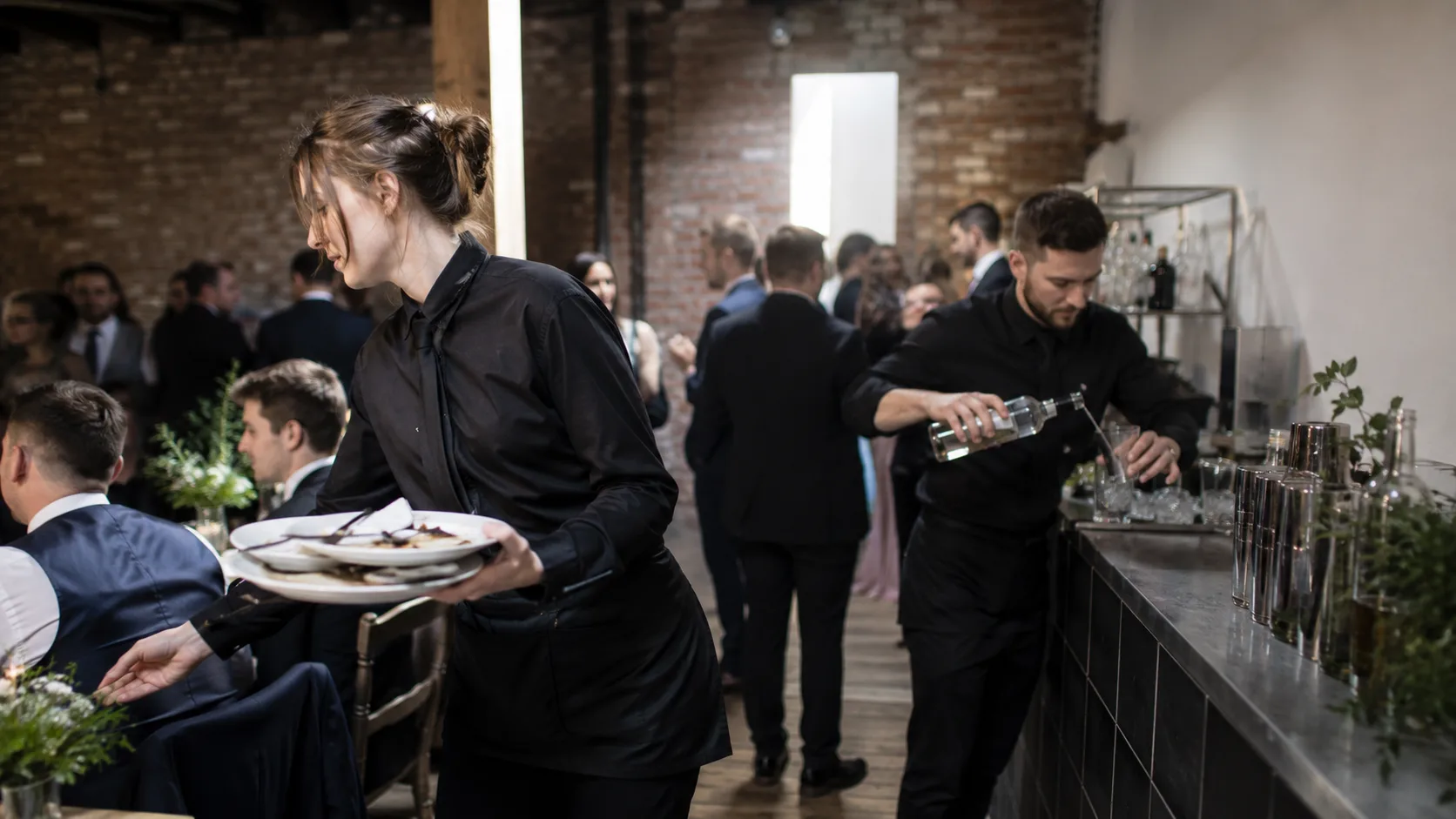 the UK event staff clearing a wedding reception in a brick venue
