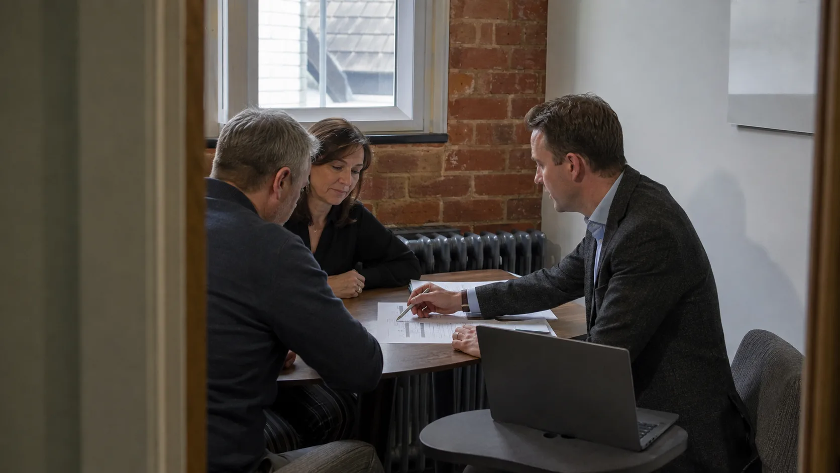 A financial adviser holds a planning review with a client in the UK