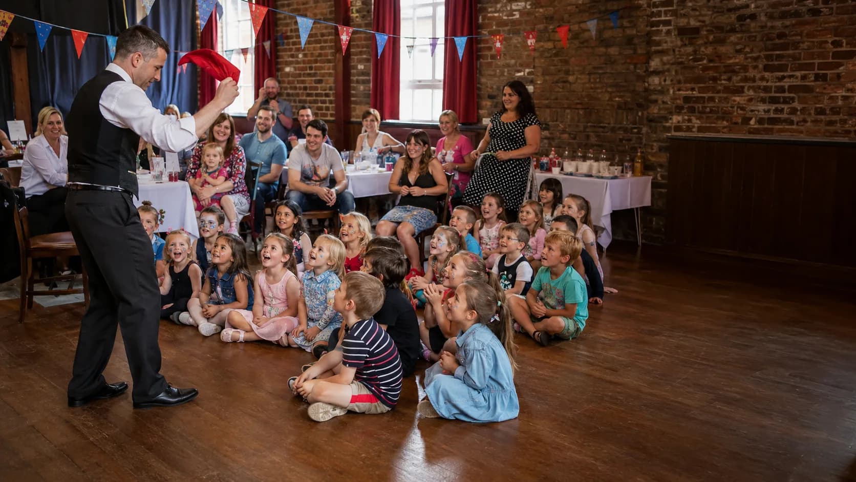 Children’s entertainer leading a cheerful party activity for families in the UK
