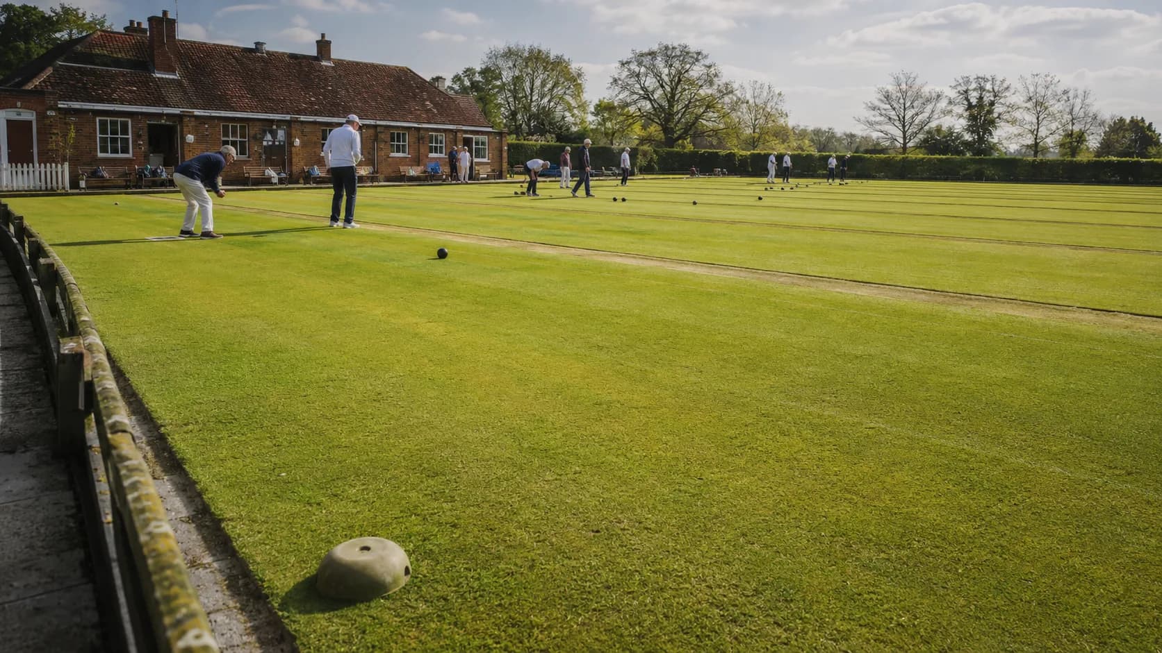 League bowlers compete on a striped club green in the UK
