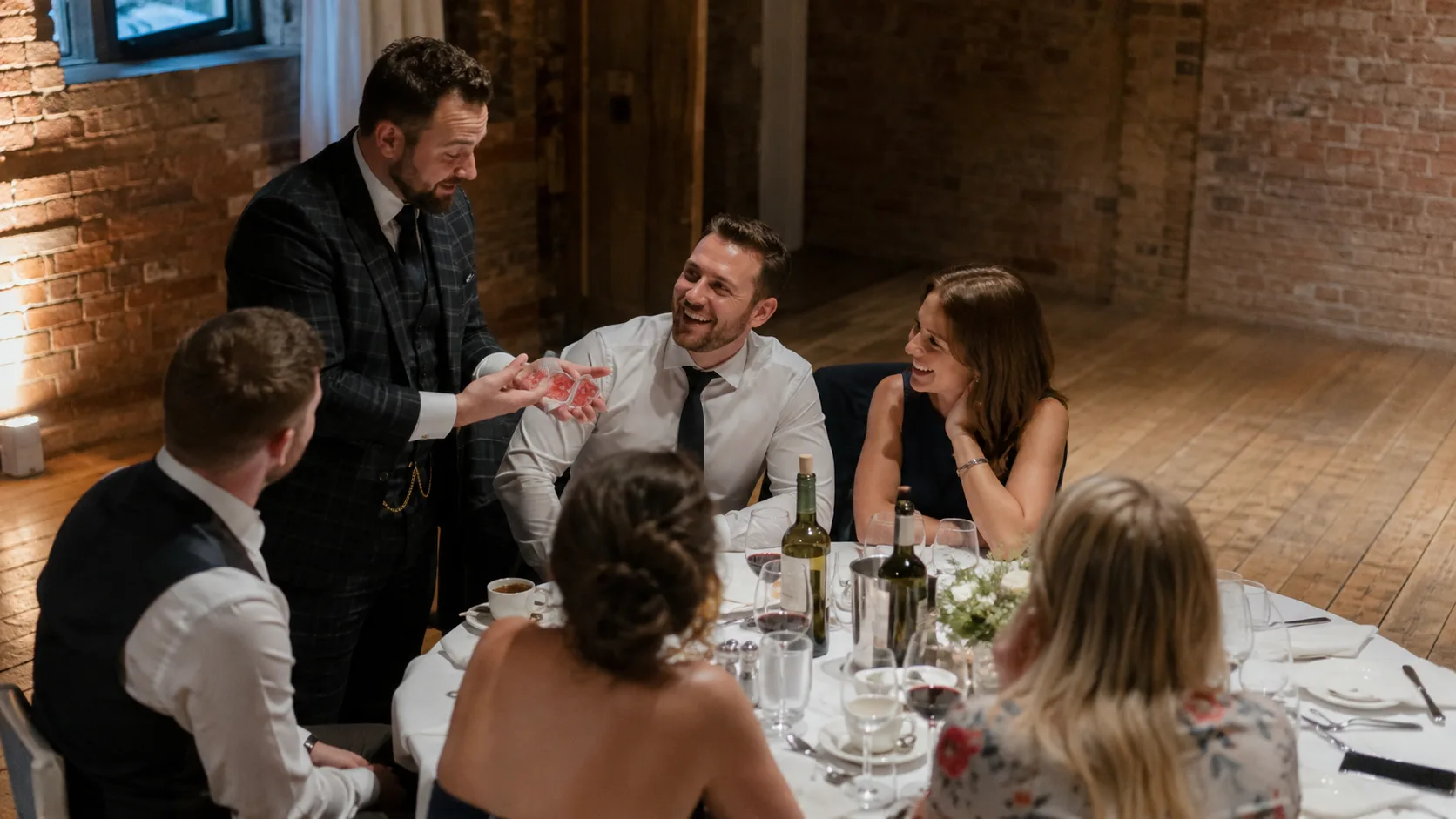Magician performing close-up magic for delighted event guests in the UK