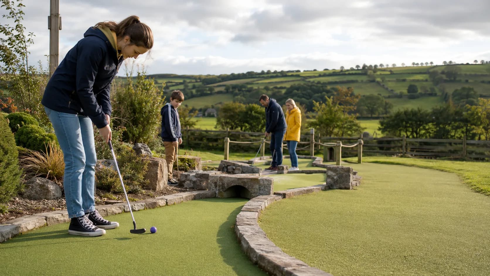 Families play a landscaped adventure golf course at a UK seaside resort