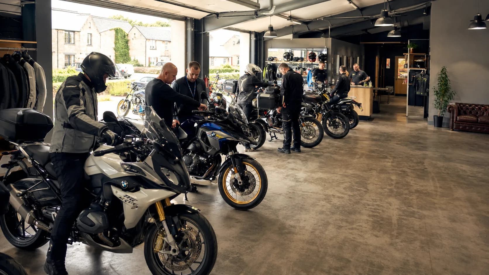 Customers collect booked motorcycle model from a busy counter in the UK