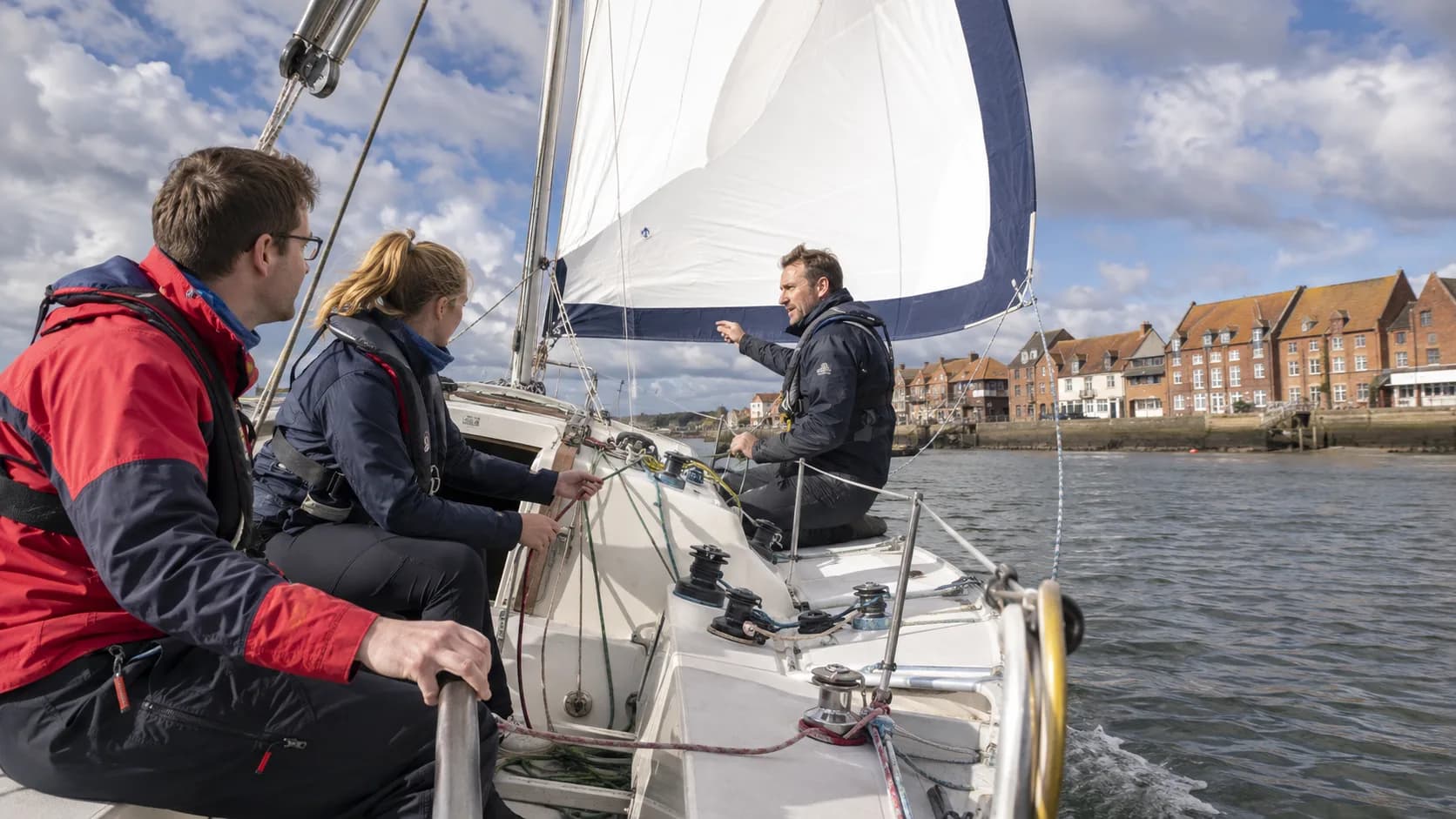 Students practise a keelboat tack during a sailing course in the UK