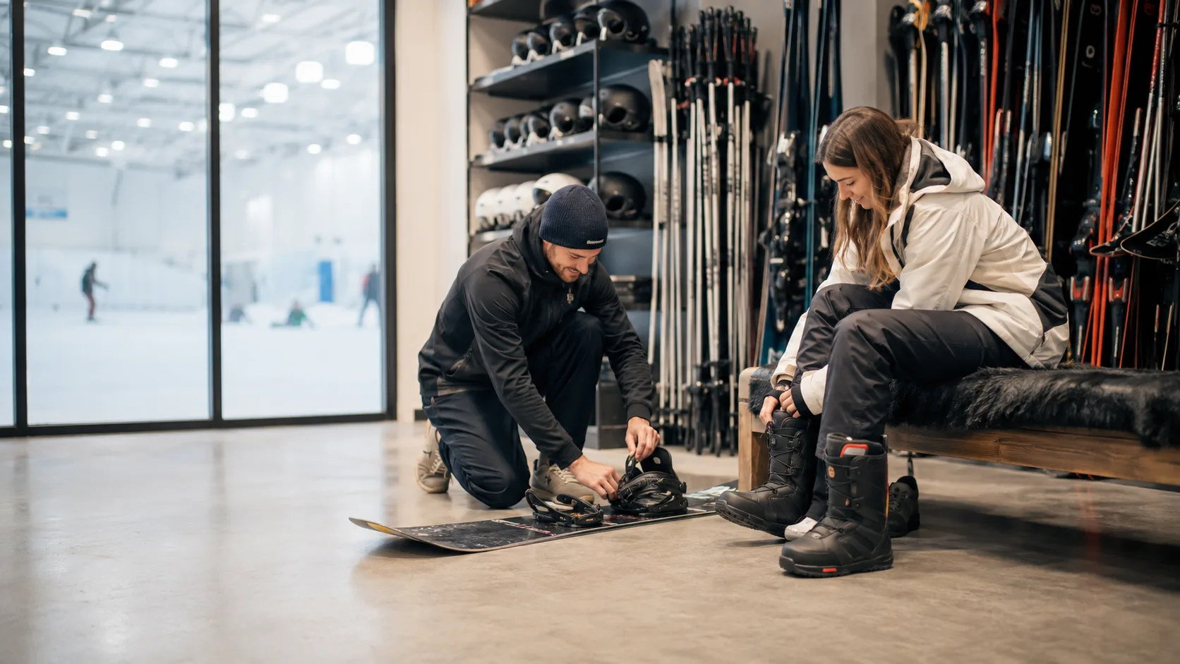 Technician adjusting ski bindings inside a busy shop in the UK
