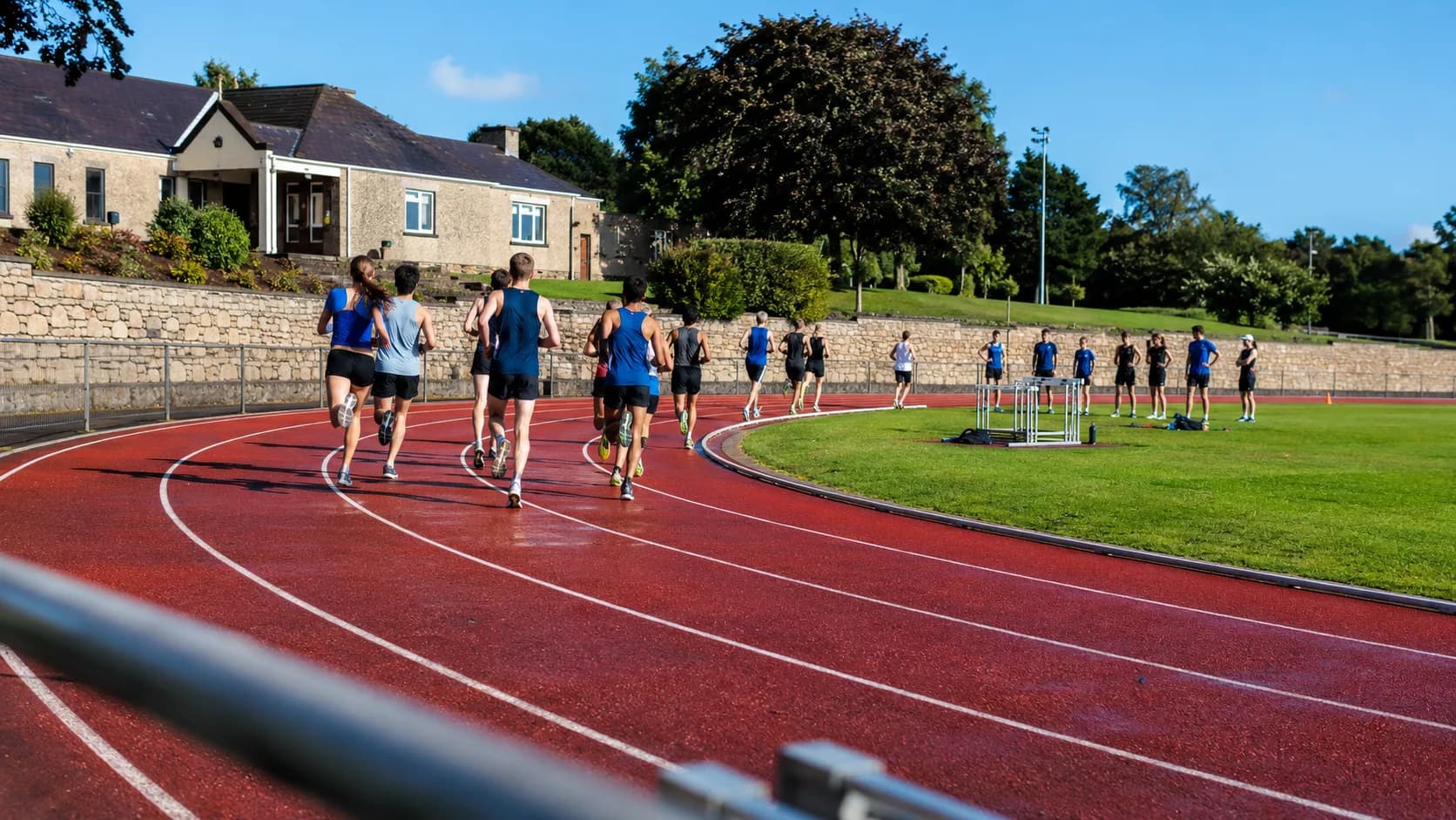 Runners use a floodlit athletics track at an Irish community ground