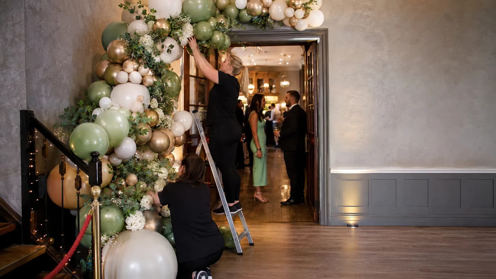 Balloon stylist installing colourful event decor for a booked celebration in Ireland