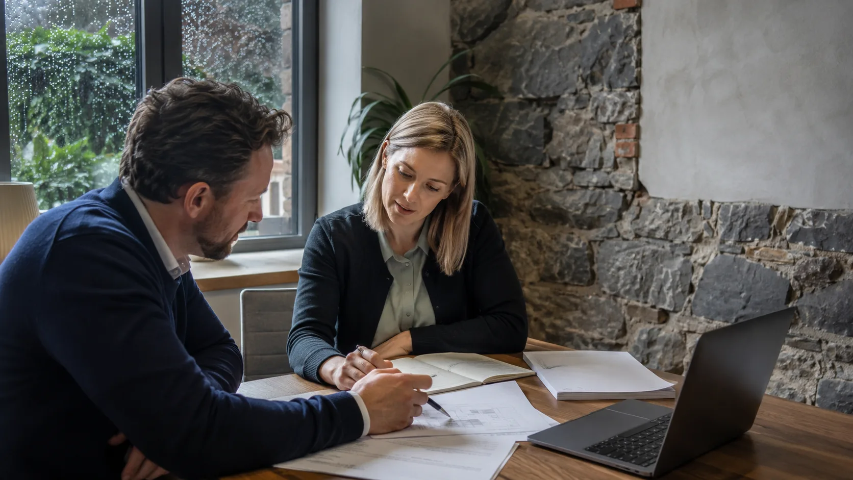 A business consultant reviews an operating plan with a client in Ireland