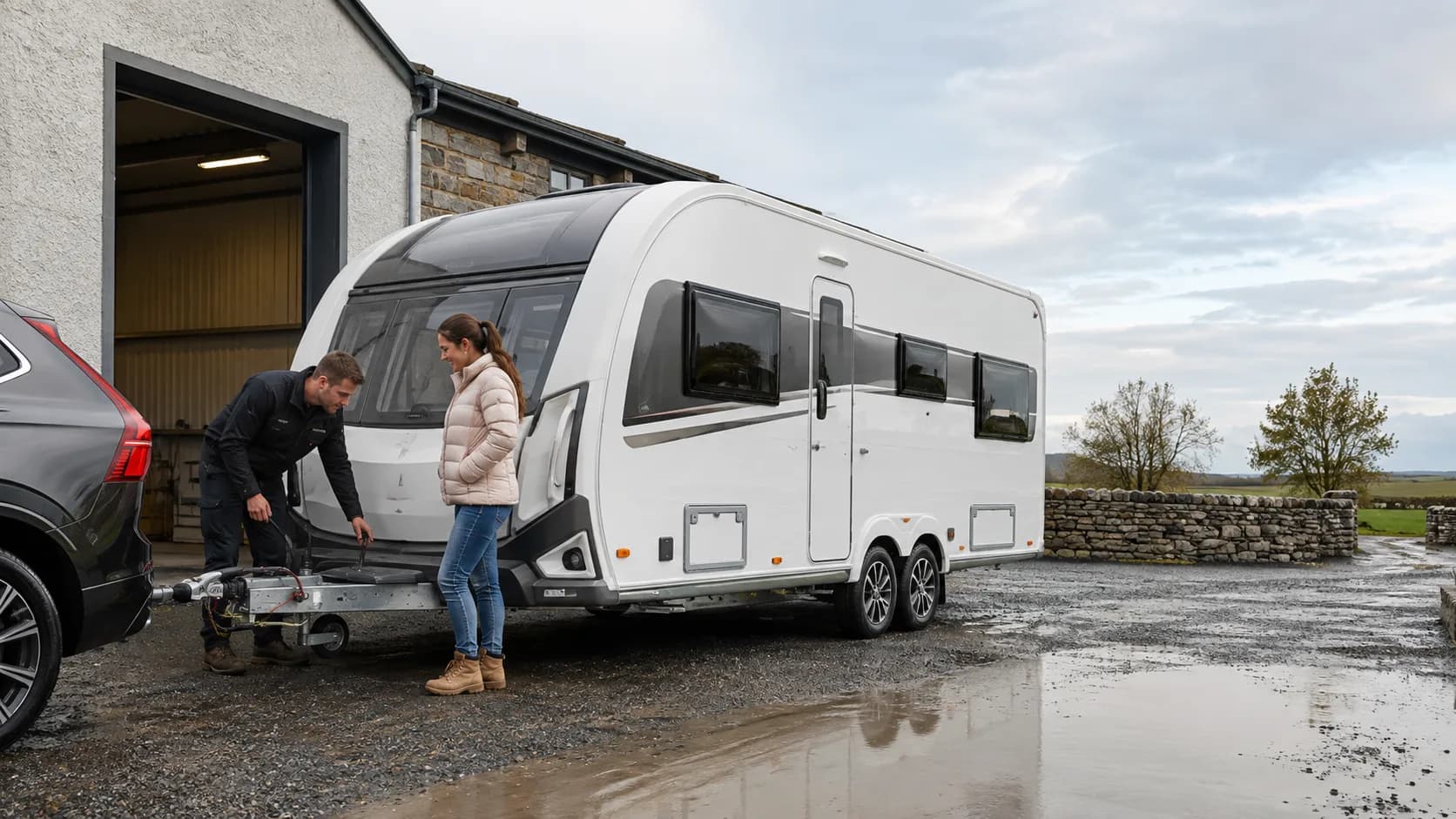 Operator checking a caravan hitch at a wet yard in Ireland