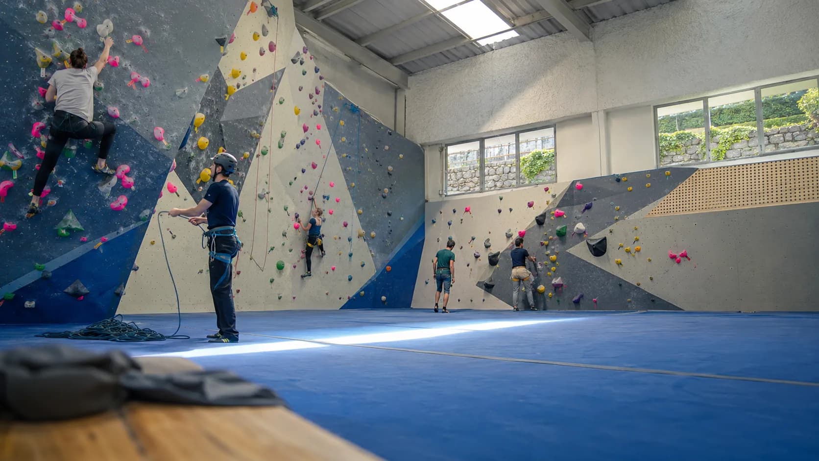 Small groups climb beneath rooflights at an indoor centre in Ireland