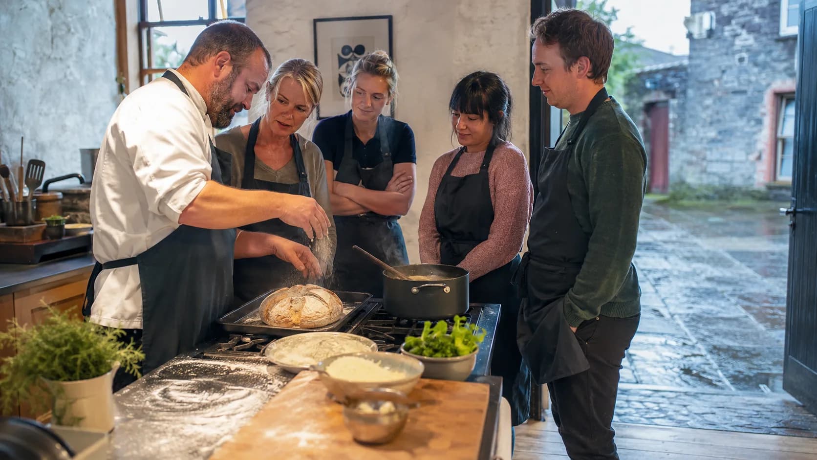A chef tutor guides participants through a hands-on cooking workshop in Ireland