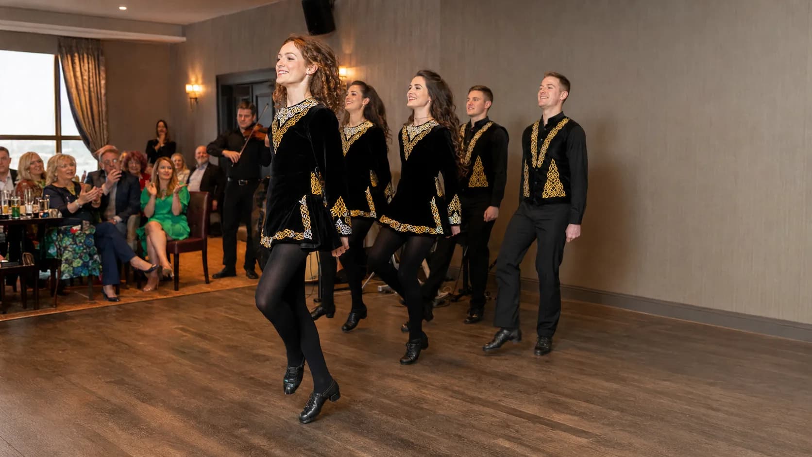 Dance troupe performing for a gathered event audience in Ireland