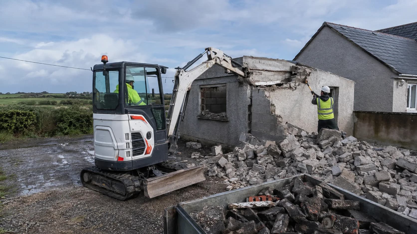 An excavator taking down a detached garage in Ireland