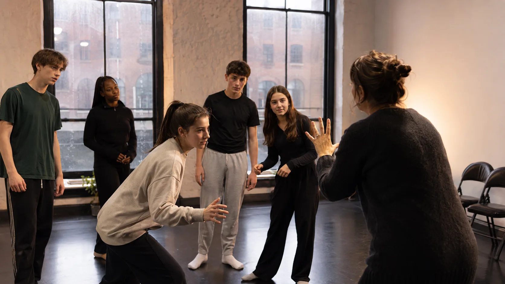 Facilitator leading a youth drama exercise at an arts centre in Ireland