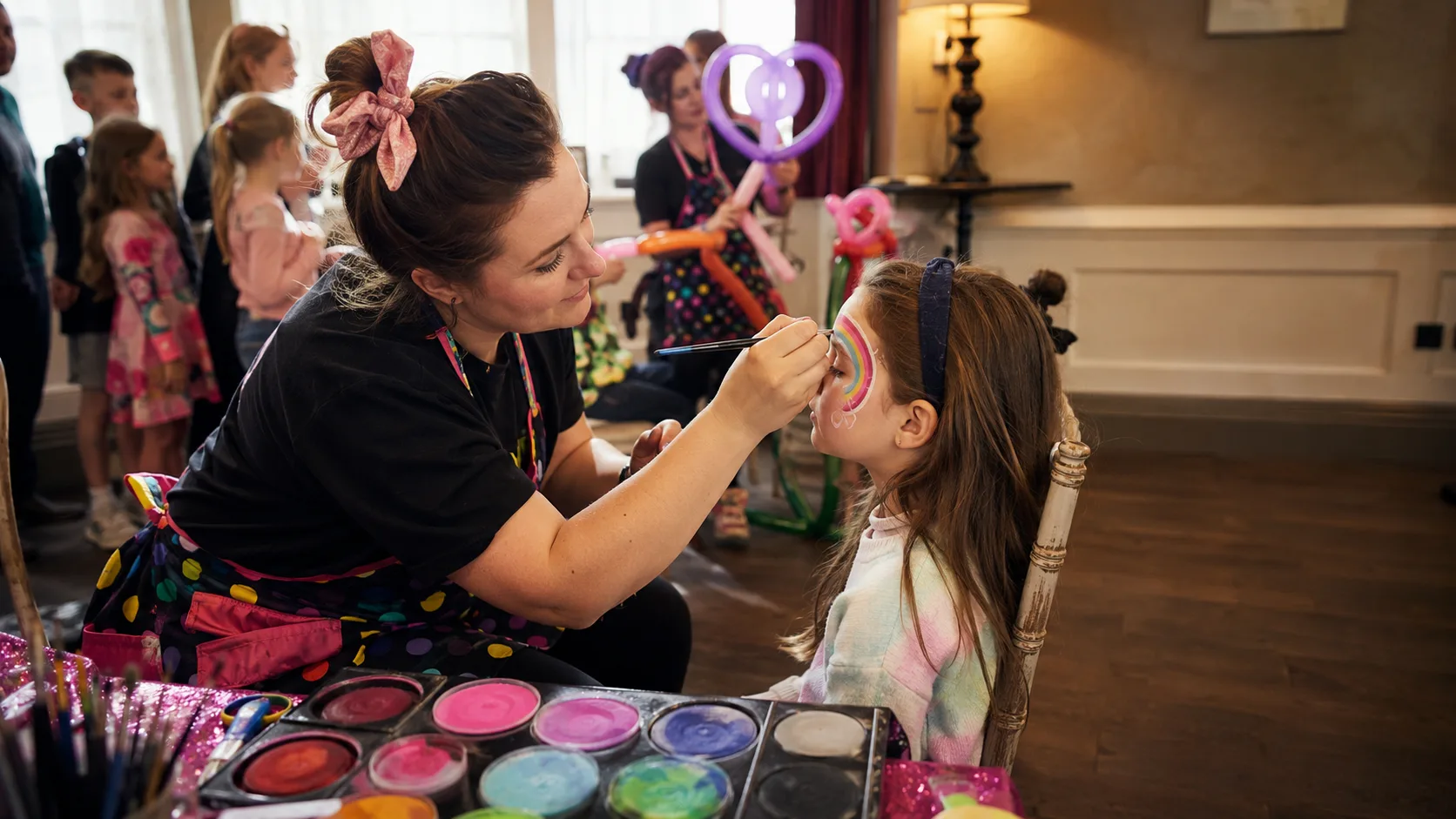 Face painter working at a busy family event in Ireland