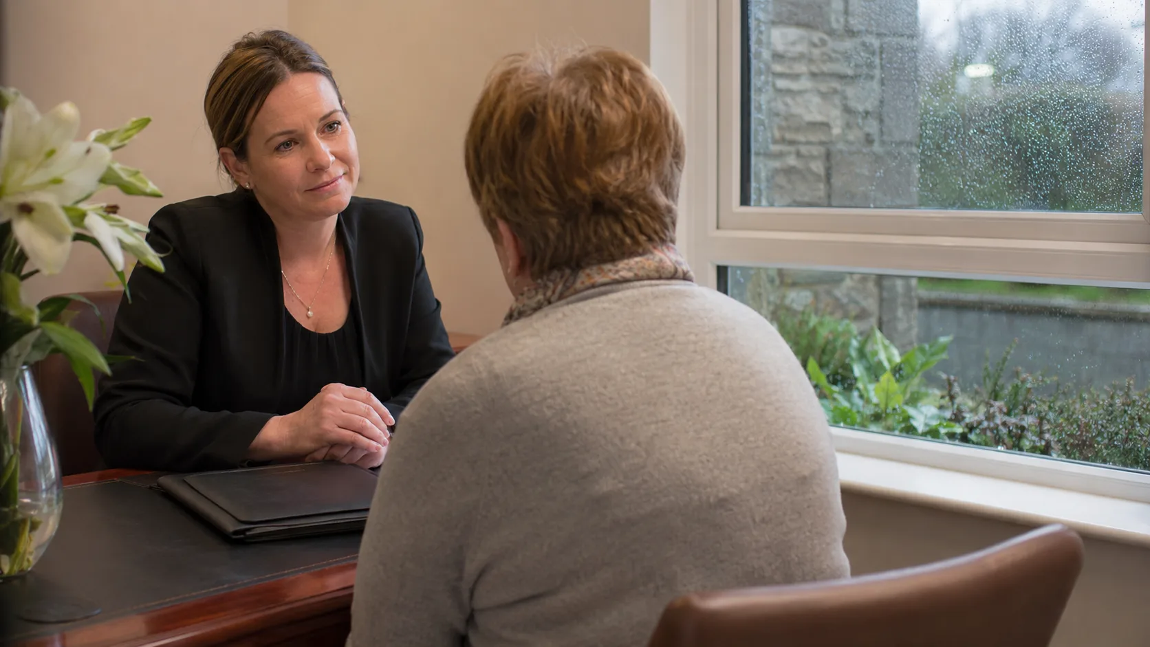 A funeral director listens during a private family appointment in Ireland