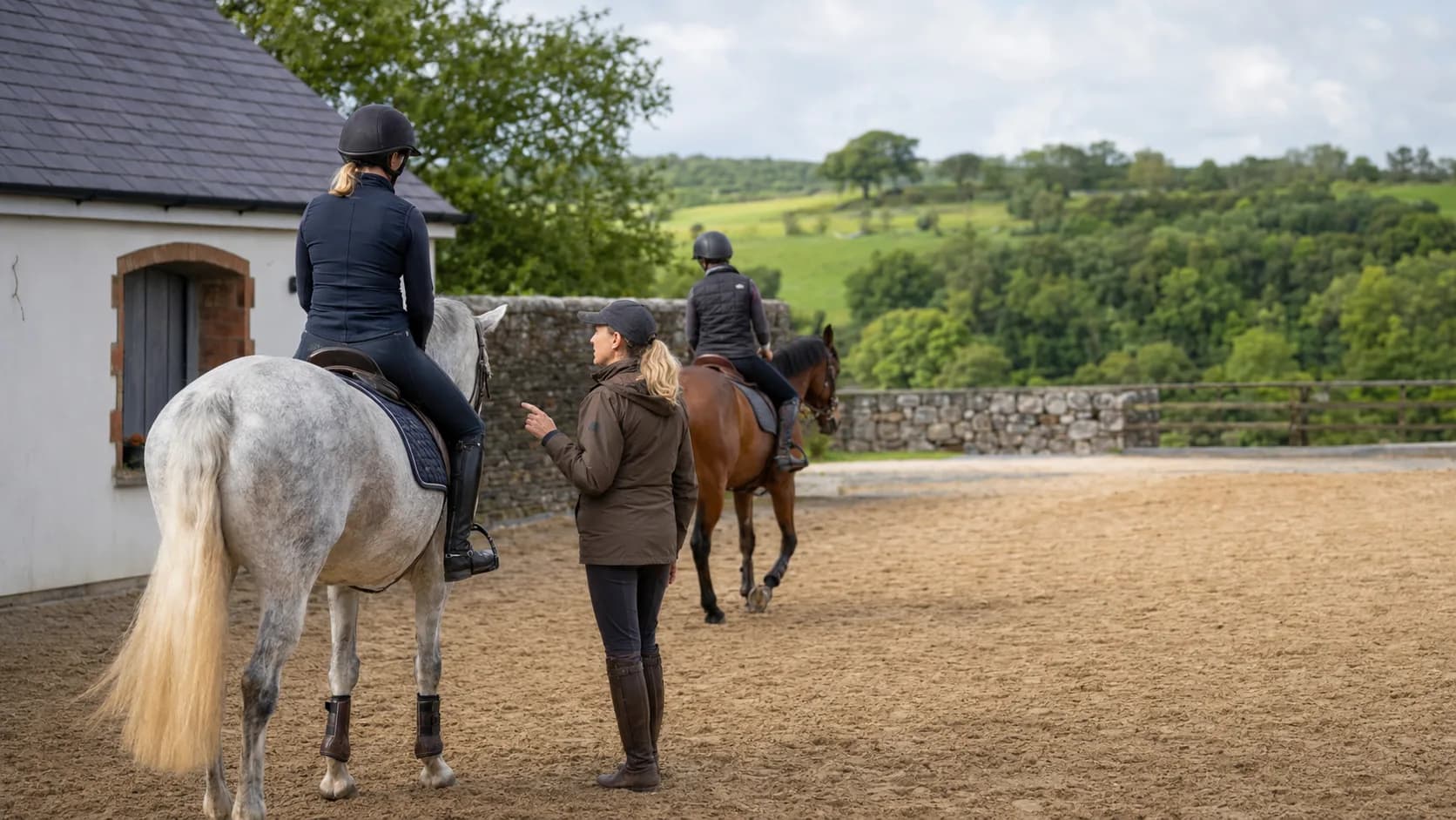 Instructor teaching a rider at a rural equestrian centre in Ireland