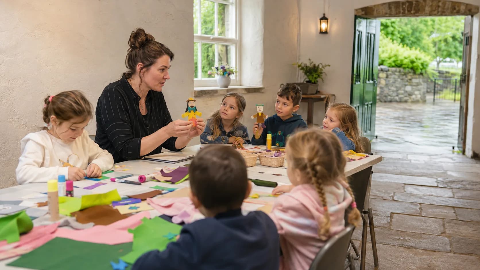 A teacher guides children through a lively hands-on activity class in Ireland